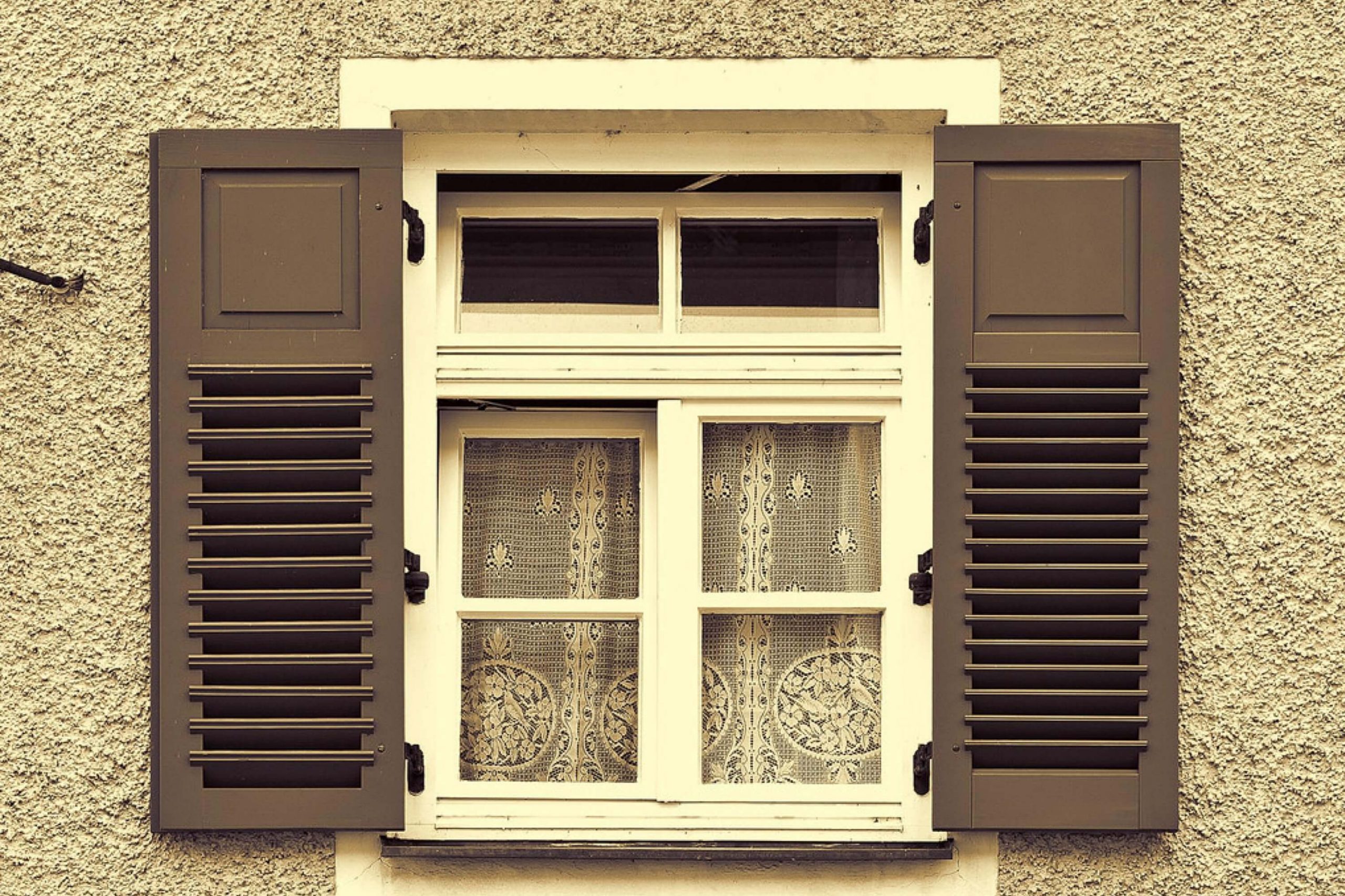 Gray Shutters On a Tan Facade