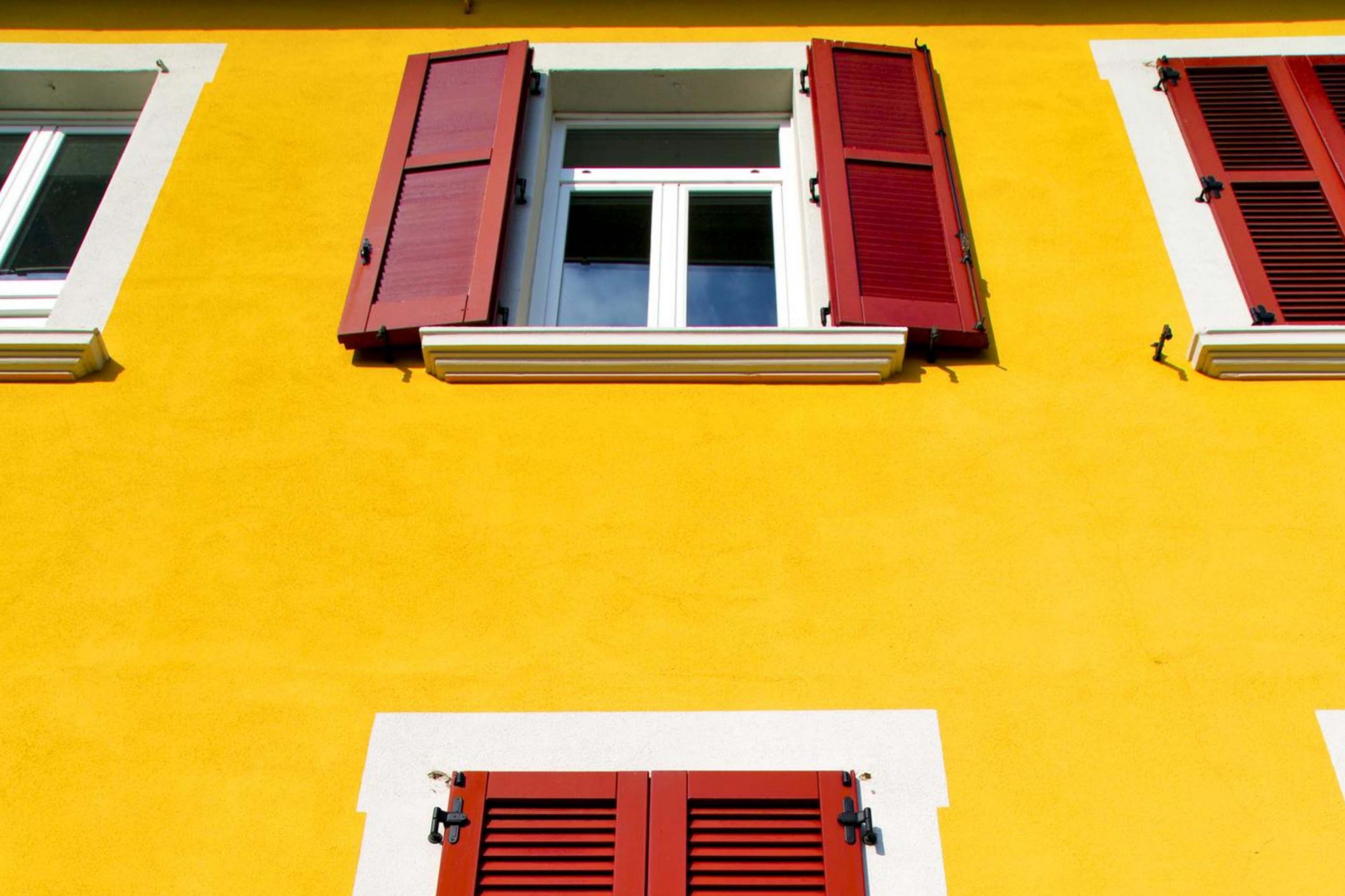 Red Shutters On Tan Siding