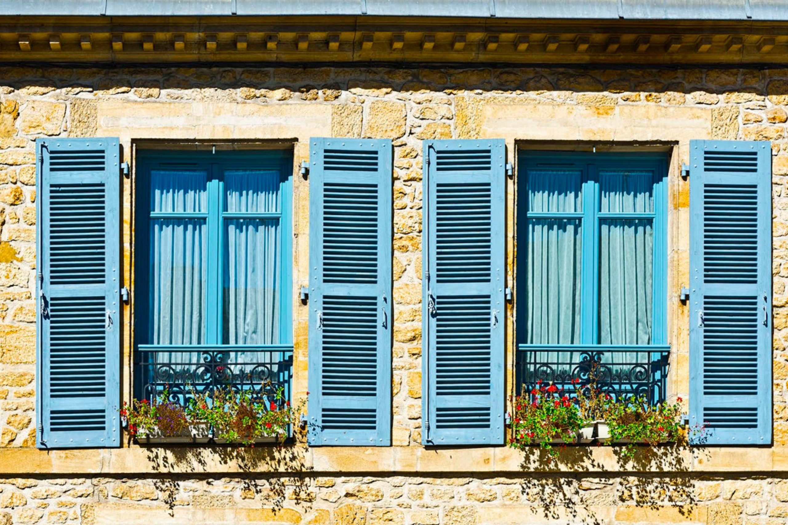 Tan House With Blue Shutters